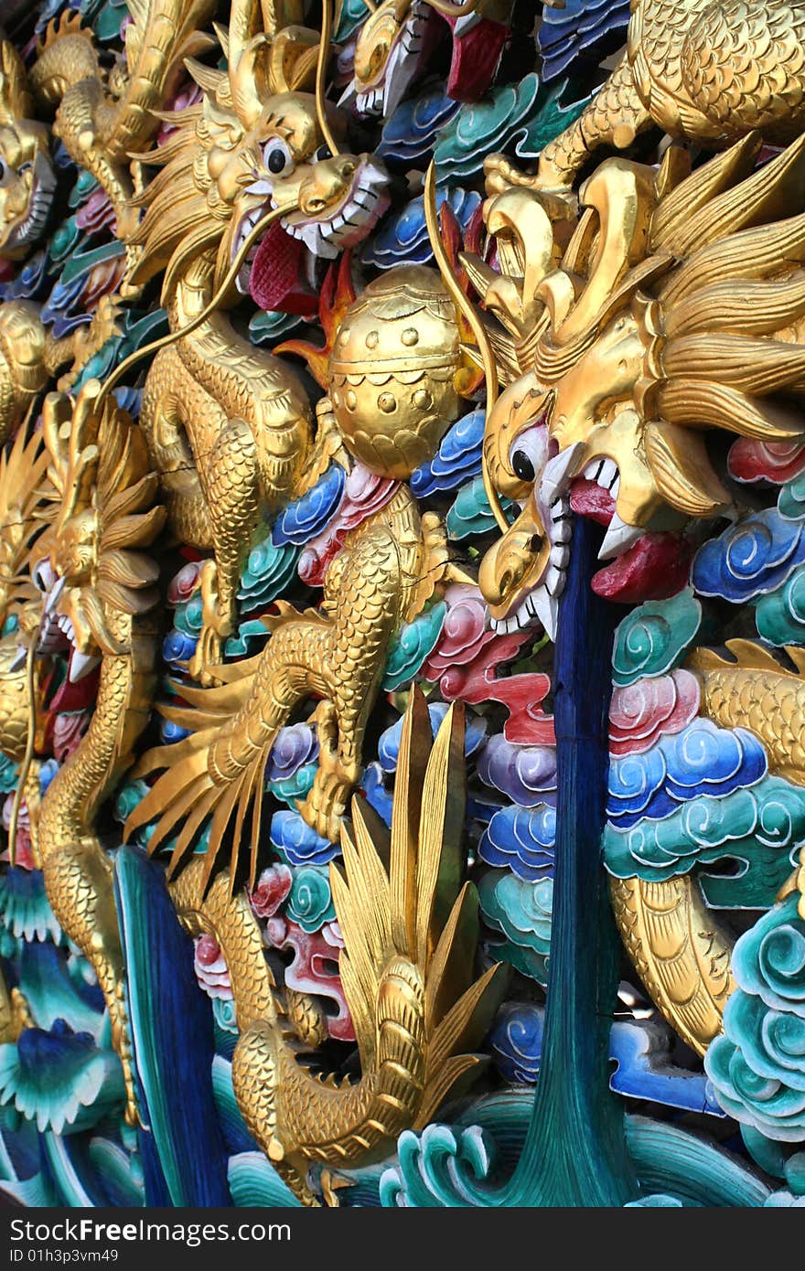 Painted dragons fightingon an ancient temple wall in Kunming, China. Painted dragons fightingon an ancient temple wall in Kunming, China