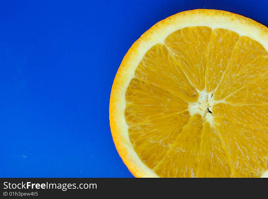 Orange slice on blue background. Orange slice on blue background