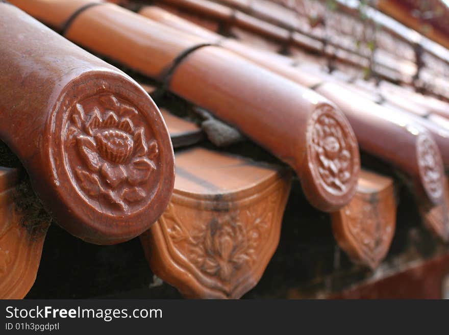 Traditional chinese roof tiles in a temple in Kunming, China.