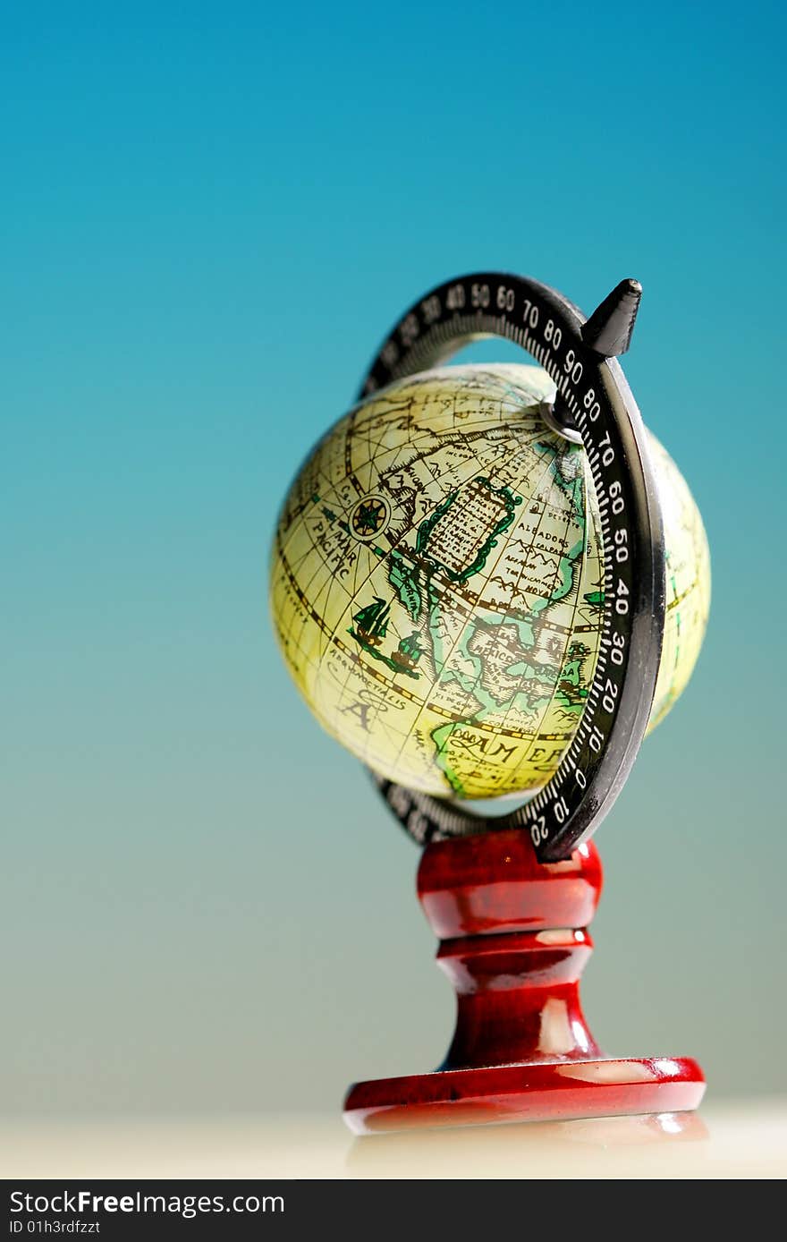 A small globe on white blue background. A small globe on white blue background