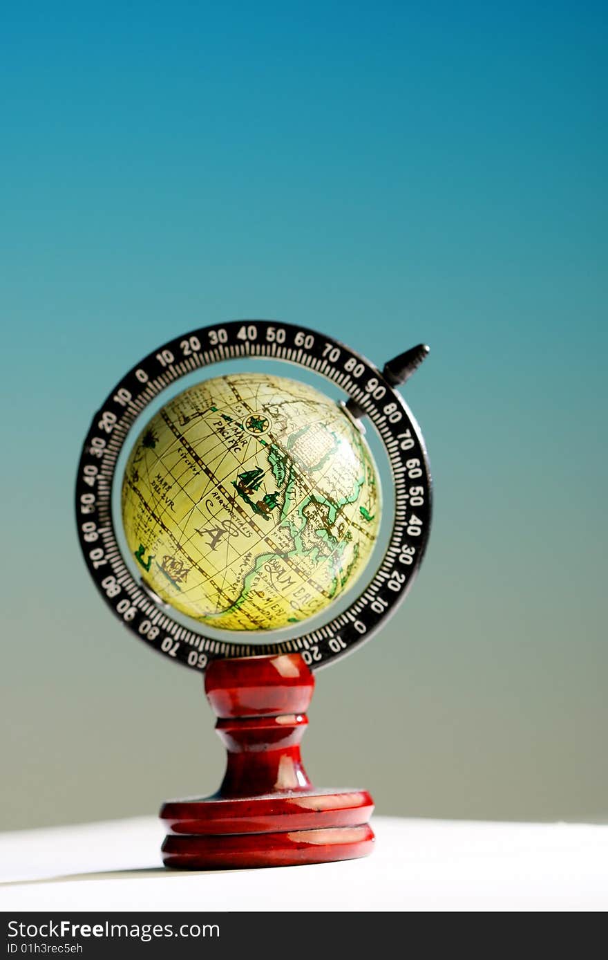 A small globe on white blue background. A small globe on white blue background