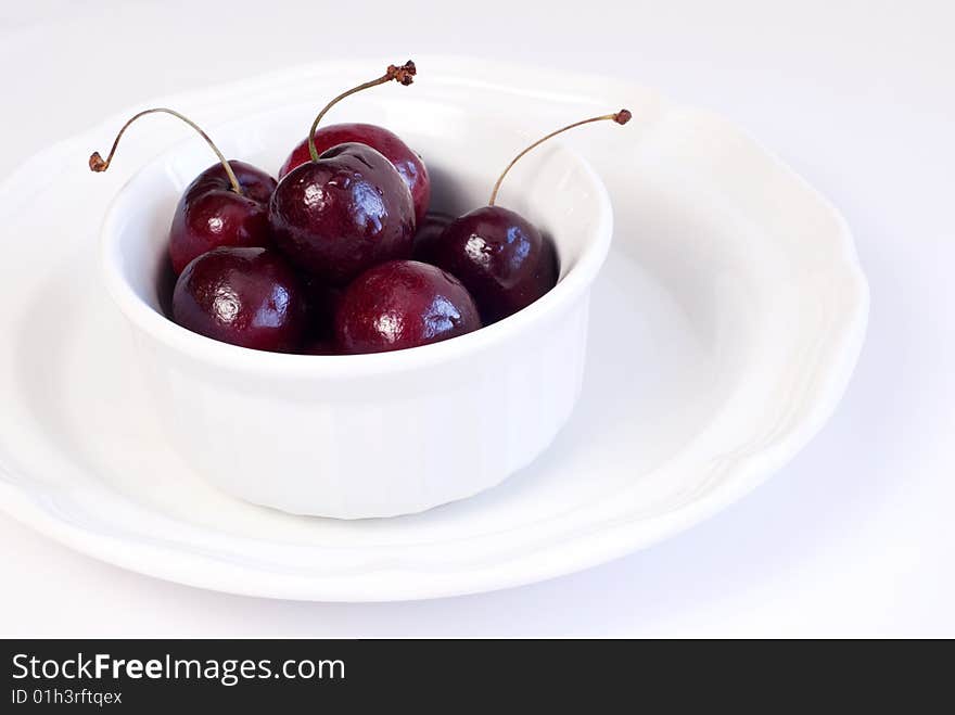 Bowl of fresh juicy cherries  on a plate copy space. Bowl of fresh juicy cherries  on a plate copy space