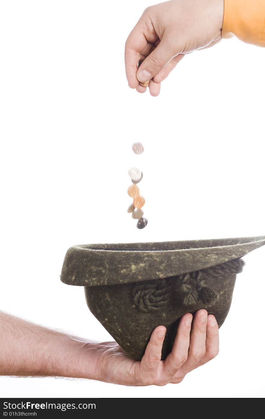 Man hand throw coins to hat in other. Man hand throw coins to hat in other