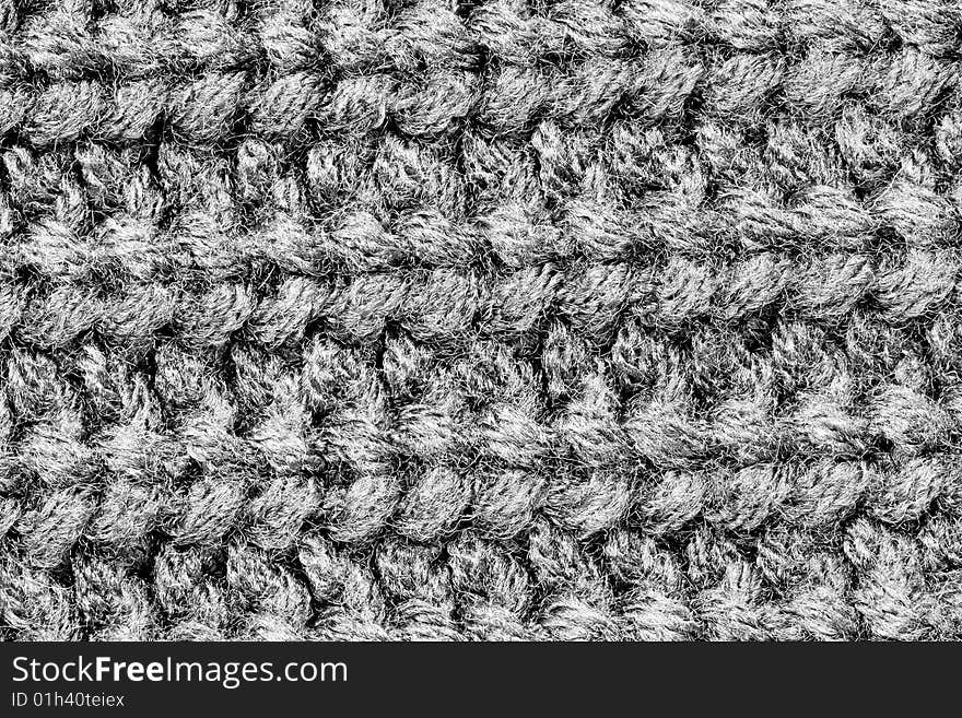 A close-up of the texture of grey woolen fabric. A close-up of the texture of grey woolen fabric
