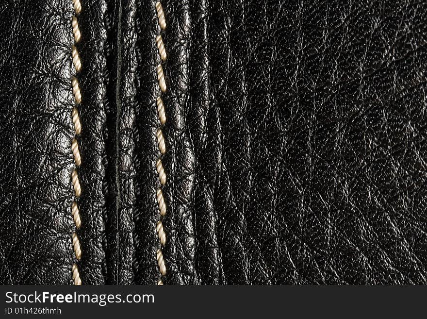 Black leather. Good, clear texture. Shining seam.