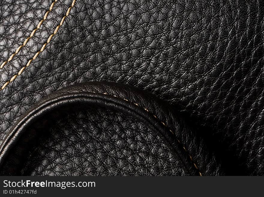 Black leather. Good, clear texture. Shining seam.