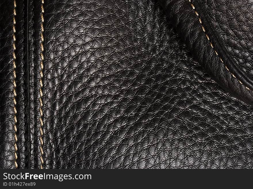 Black leather. Good, clear texture. Shining seam.