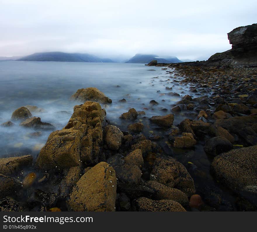 Coastal landscape by a rainy and windy day at Elgol port in scotland, isle of skye.