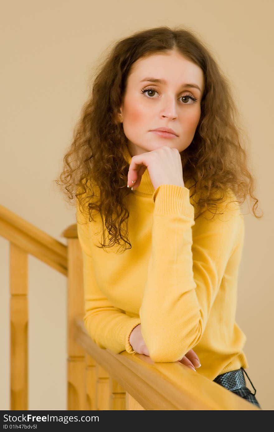 Beautiful young woman standing on a staircase. Beautiful young woman standing on a staircase