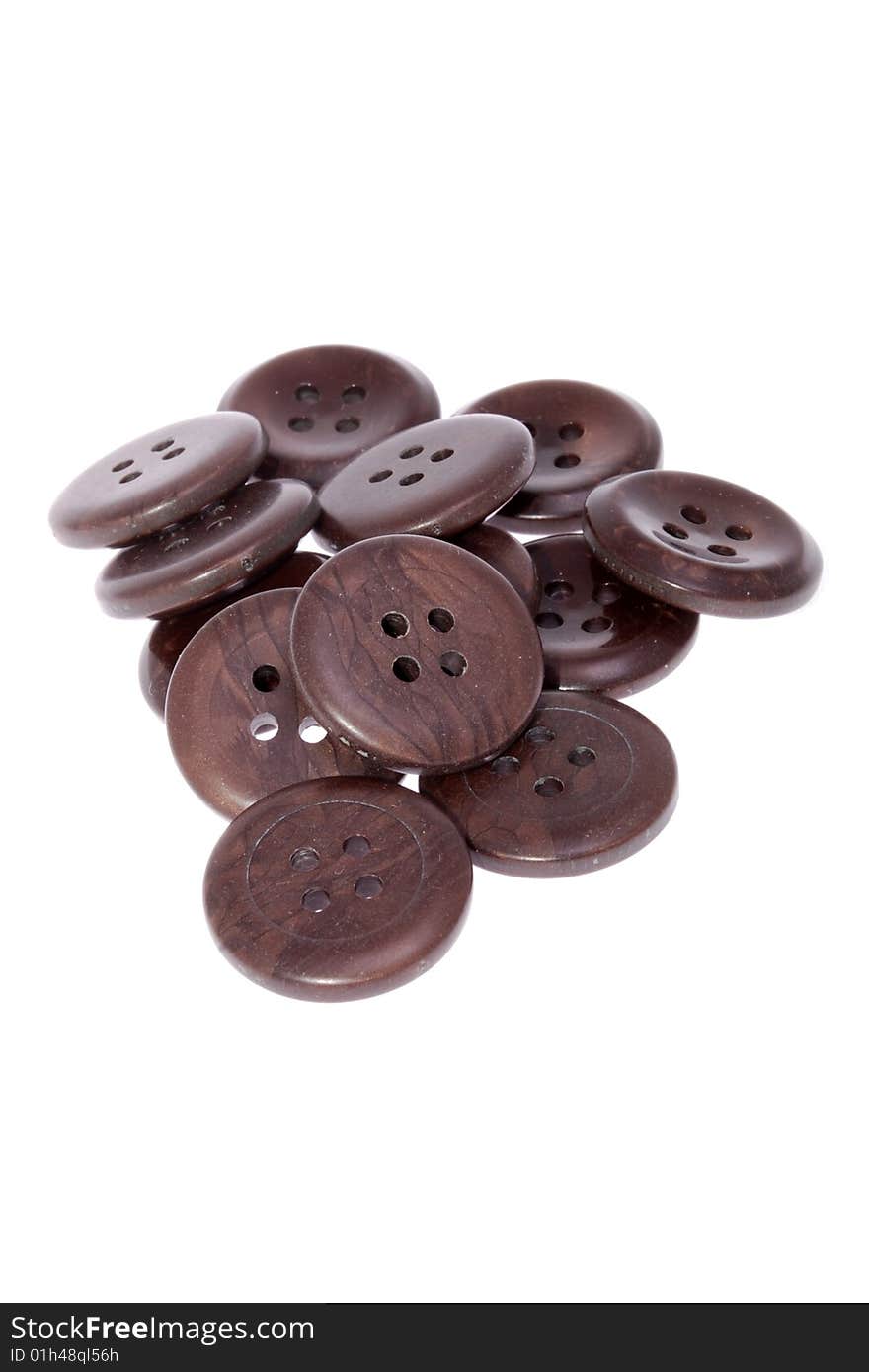 Pile of brown buttons, isolated on white background