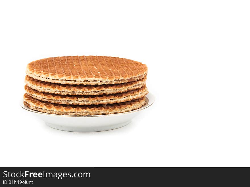 Waffles in a stack on the plate isolated over white background