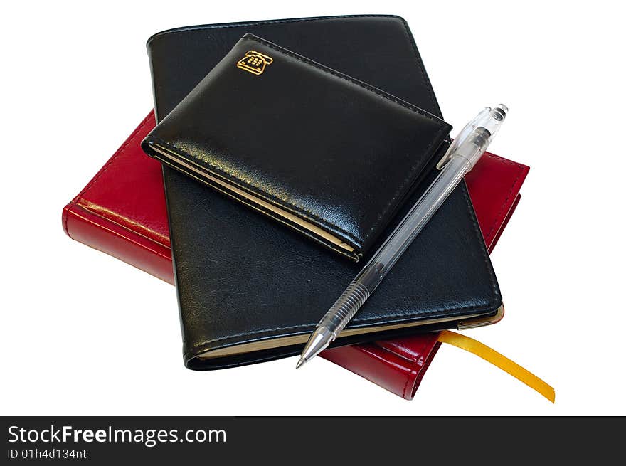 Three notebooks (organizers) and jell pen on isolated background. Three notebooks (organizers) and jell pen on isolated background.