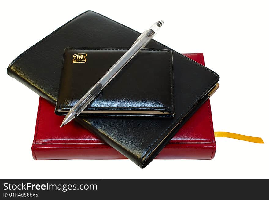 Three notebooks (organizers) and jell pen on isolated background. Three notebooks (organizers) and jell pen on isolated background.