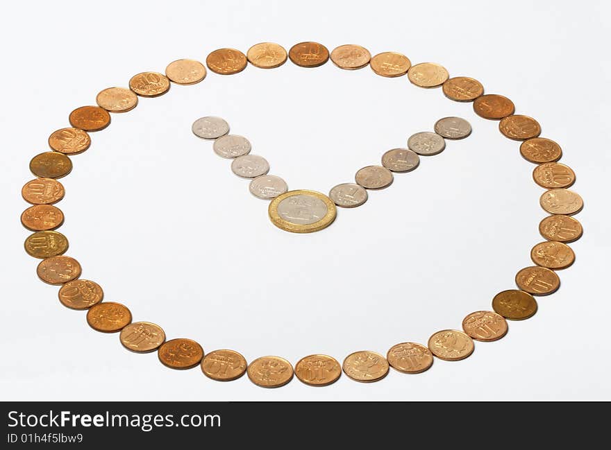 A clock made of coins on the white background. A clock made of coins on the white background