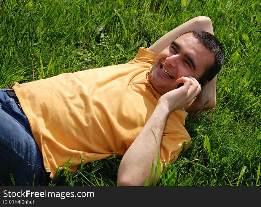 Young man smiles speaking on the phone