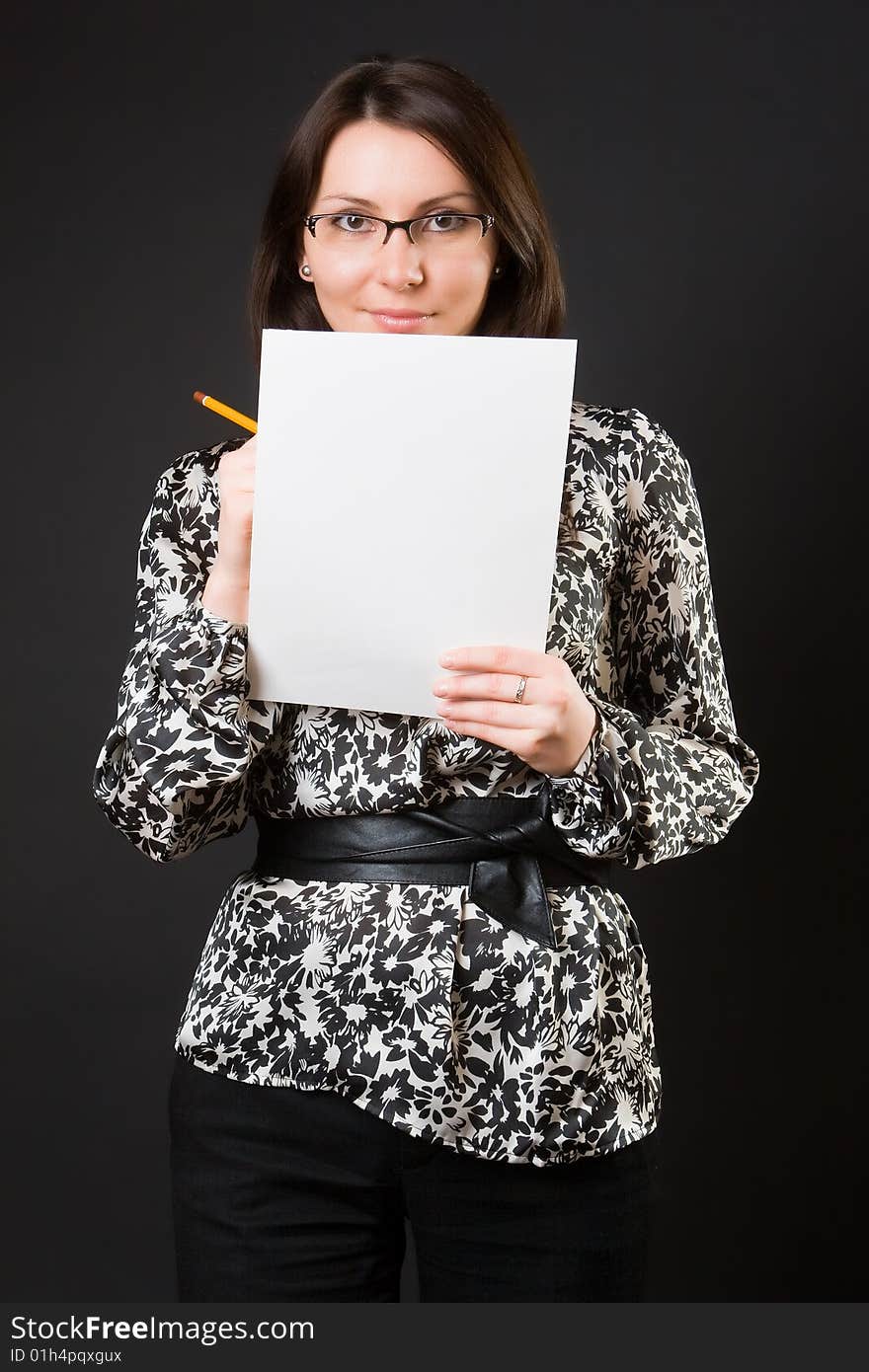 Pretty woman with a notebook against a dark background. Pretty woman with a notebook against a dark background