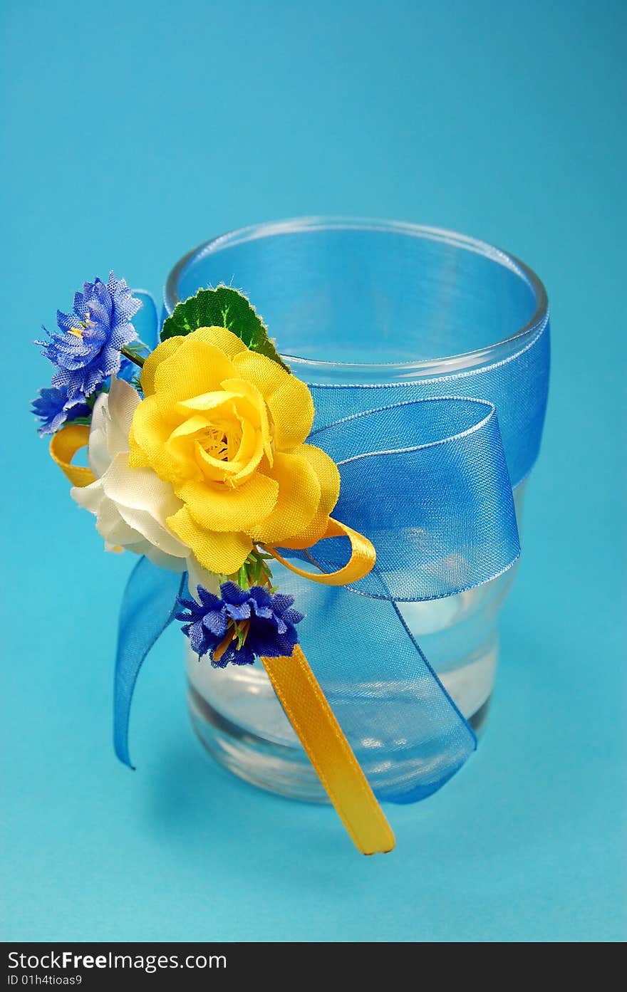 Glasses with flowers isolated on blue