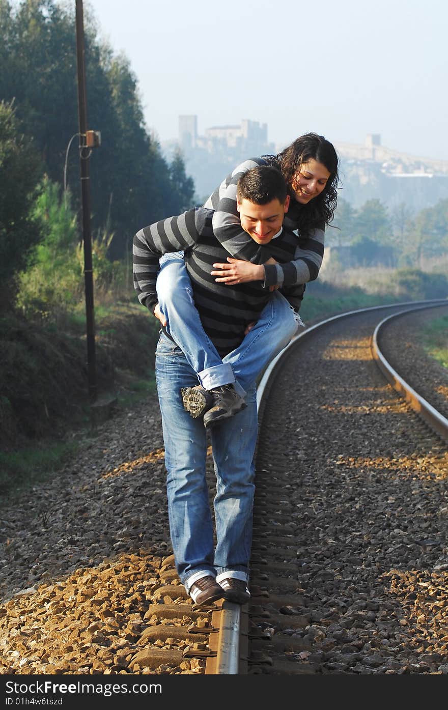 Young couple walking on railway tracks