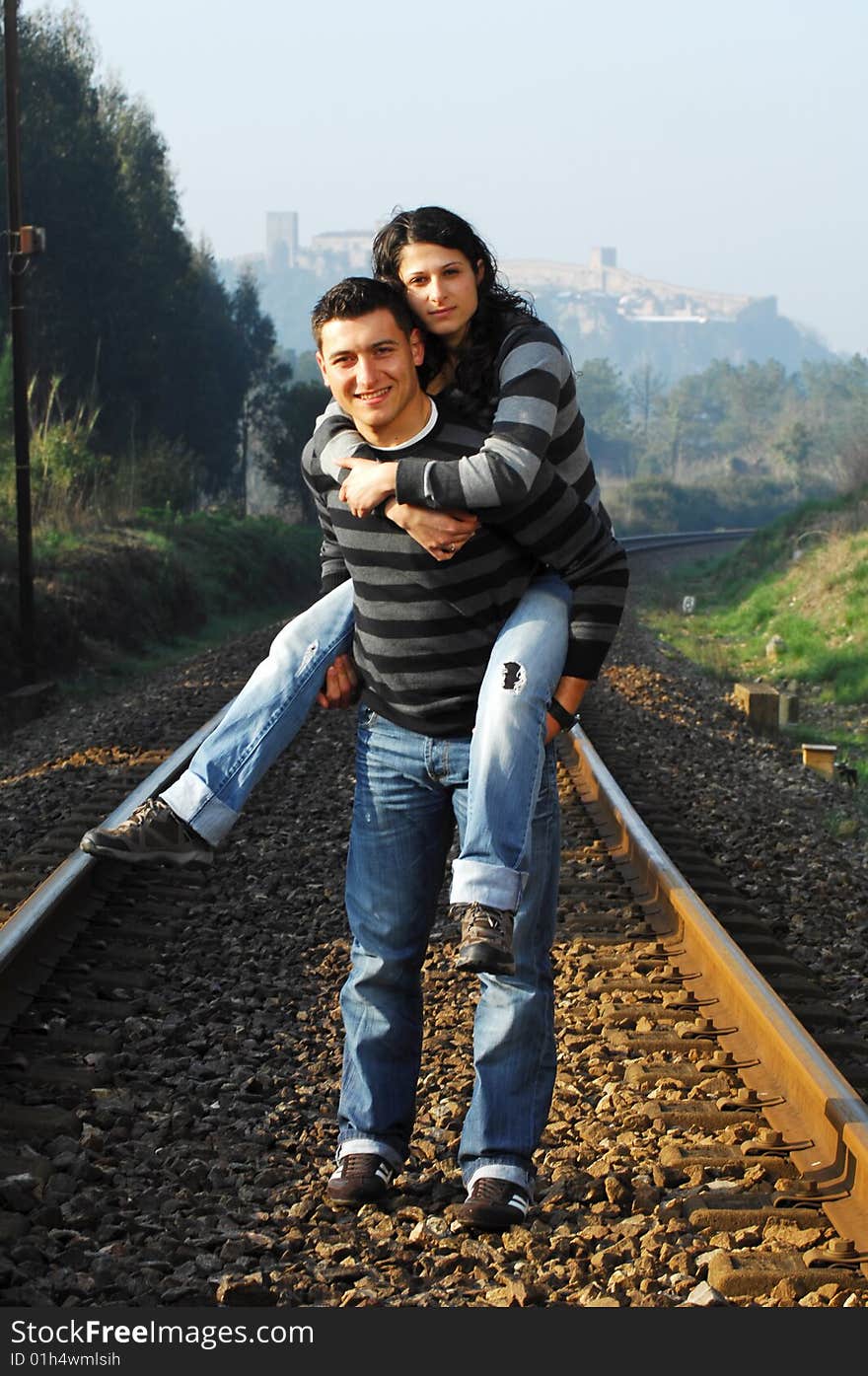 Young couple walking on railway tracks