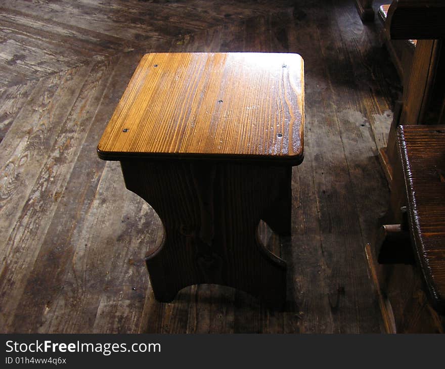 A wooden stool is in the cafe of Carpathians. A wooden stool is in the cafe of Carpathians