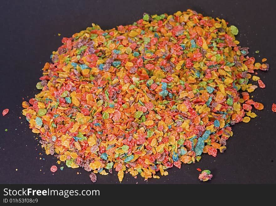 Bright colors and great textures are featured on this photograph of cereal on a black background. Bright colors and great textures are featured on this photograph of cereal on a black background