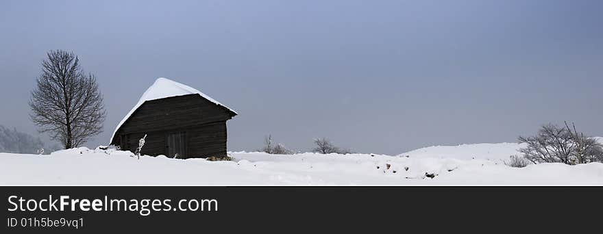 Winter landscape;Lonley house in a village in the mountains,in Romania. Winter landscape;Lonley house in a village in the mountains,in Romania