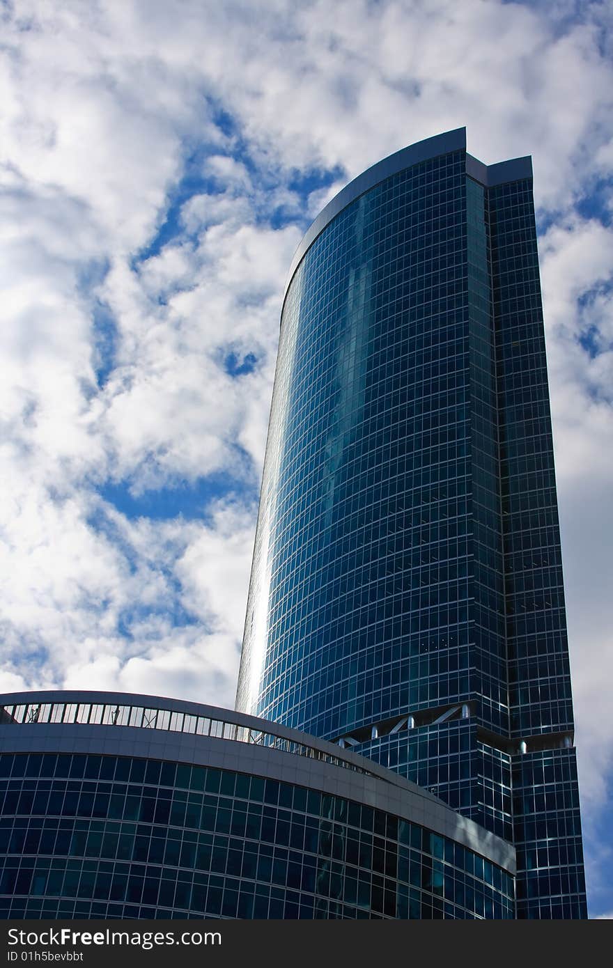 High-rise office building with cloudy sky on the background