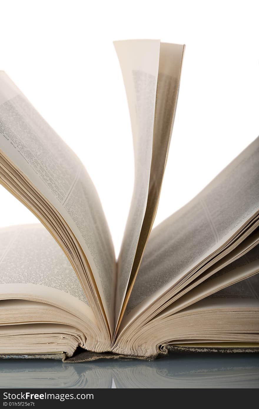 Close-up of an opened antique encyclopaedia, with random pages against white background. Close-up of an opened antique encyclopaedia, with random pages against white background