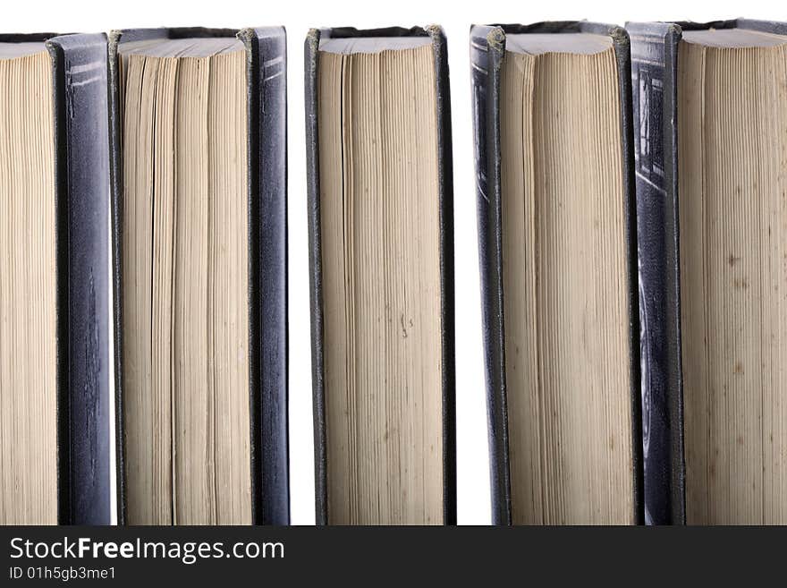 Antique leather-bound books arranged in a row, back-lit against white. Old and used encyclopaedia. Antique leather-bound books arranged in a row, back-lit against white. Old and used encyclopaedia.