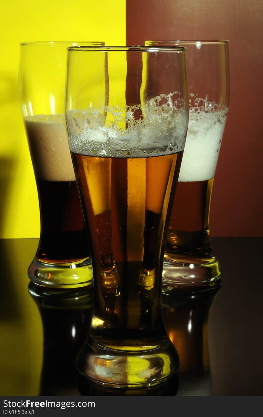 Three glasses with light and dark beer