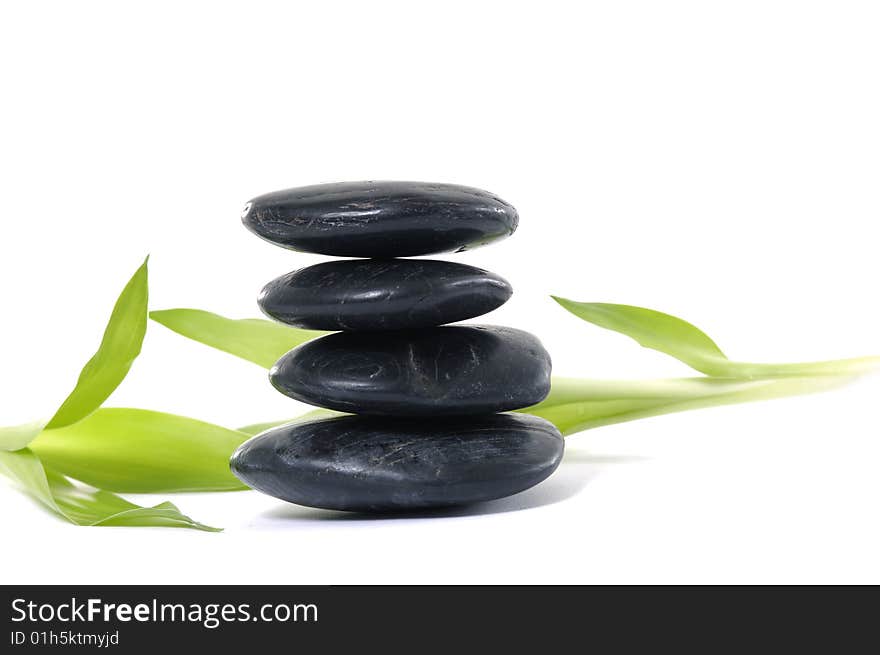 Stack pebbles with green leaves. Stack pebbles with green leaves