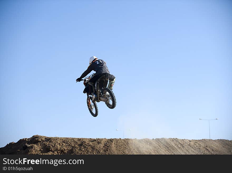 Motocross racer riding motorcycle outdoor