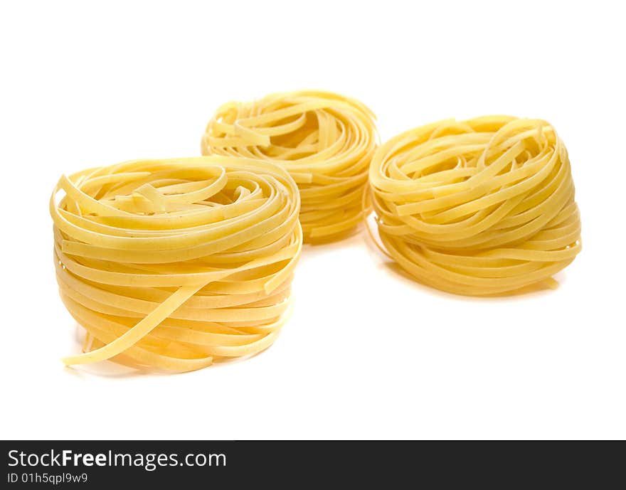 Pasta tagliatelle isolated on white. shallow dof