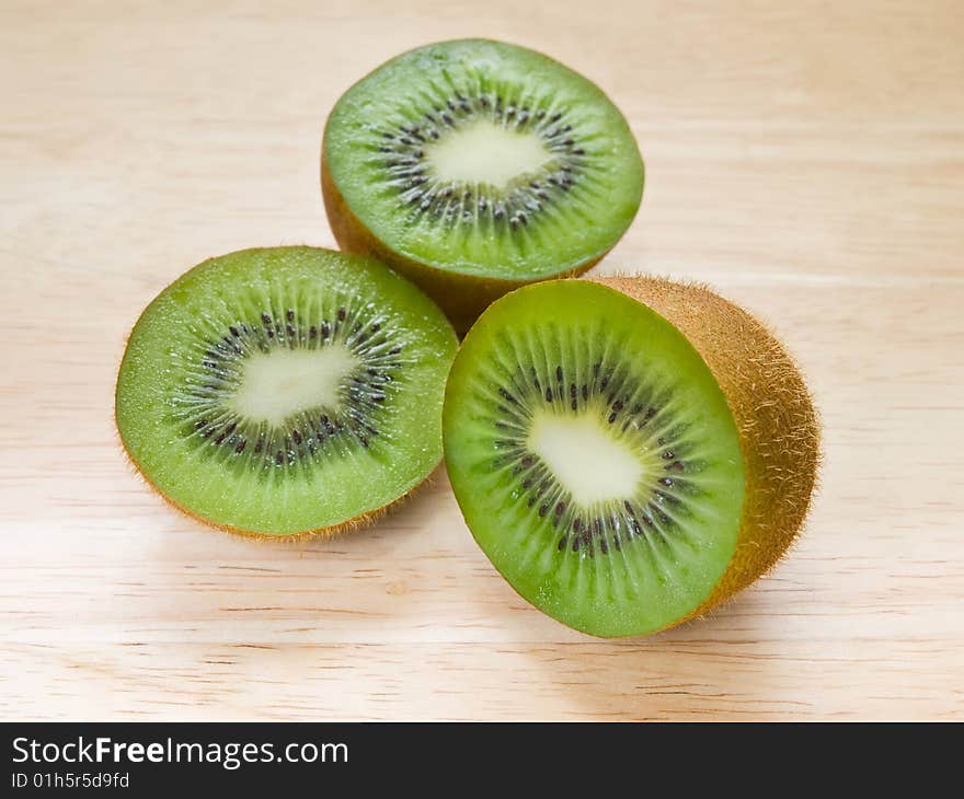 Kiwi fruit parts on wooden background. shallow dof. Kiwi fruit parts on wooden background. shallow dof