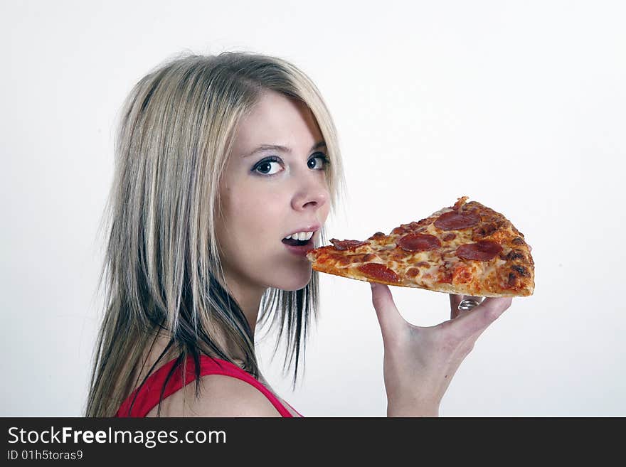 Sweet and pretty girl eating pizza slice