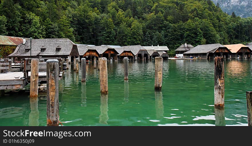 Wooden boat houses and mooring posts on Koenigssee in Bavaria, Germany. Wooden boat houses and mooring posts on Koenigssee in Bavaria, Germany