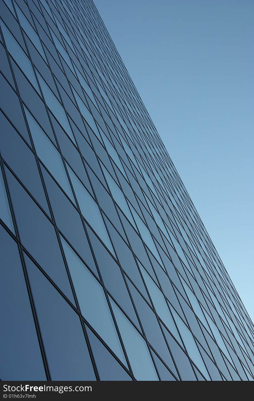 Office building in glass in background blue sky