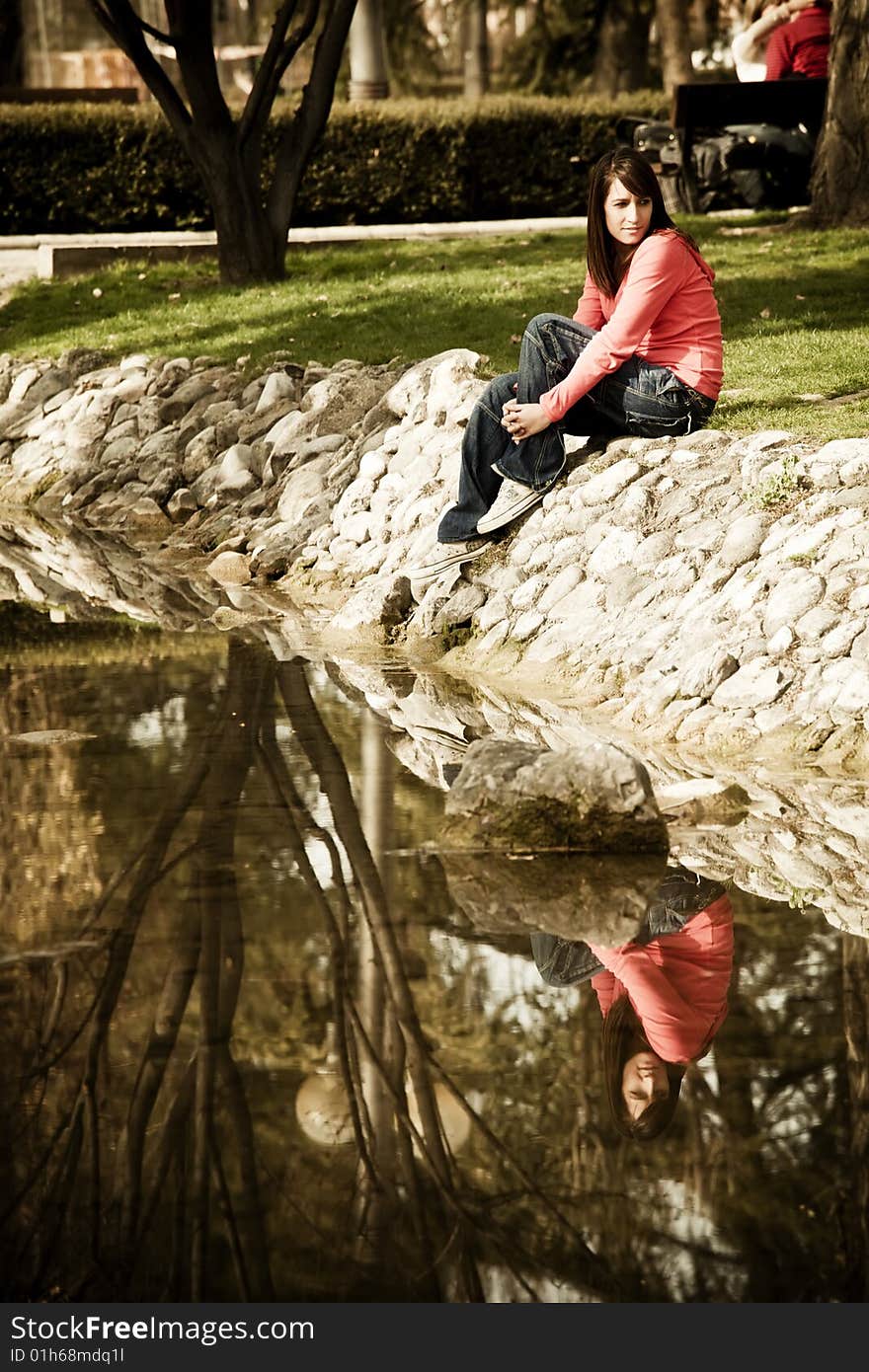 Woman sitting near the river