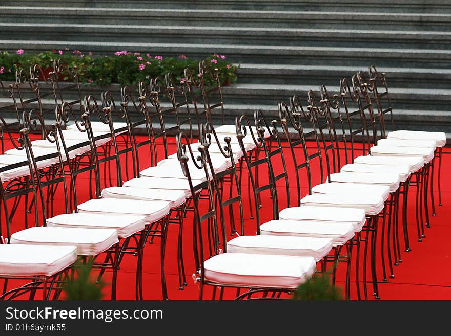 Many chairs on a red carper