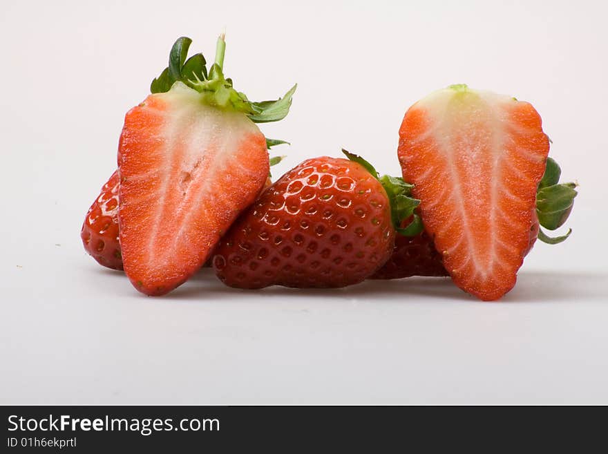 Sliced upped strawberries on a white background. Sliced upped strawberries on a white background