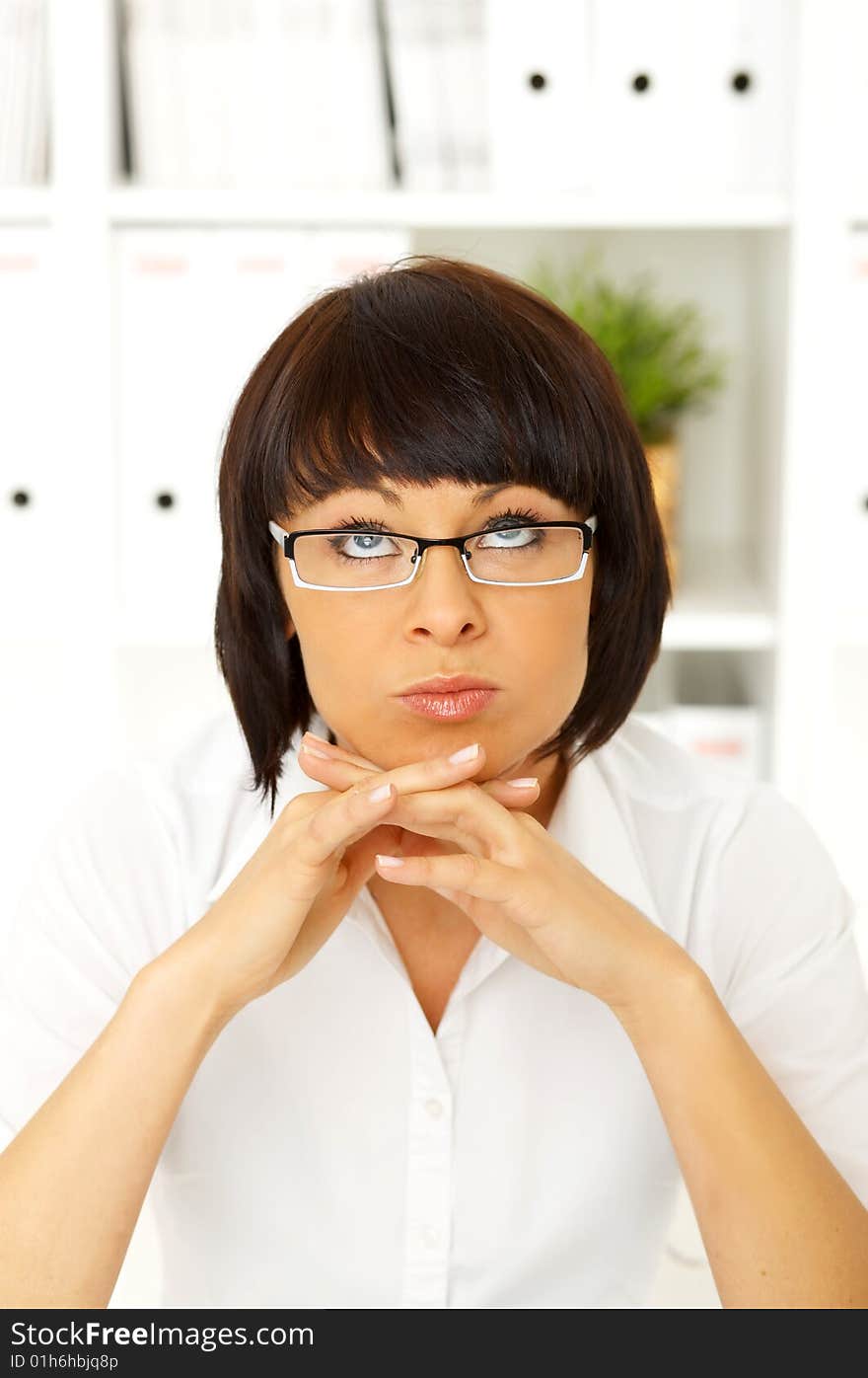 Beautiful business woman sitting at the desk in office. Beautiful business woman sitting at the desk in office