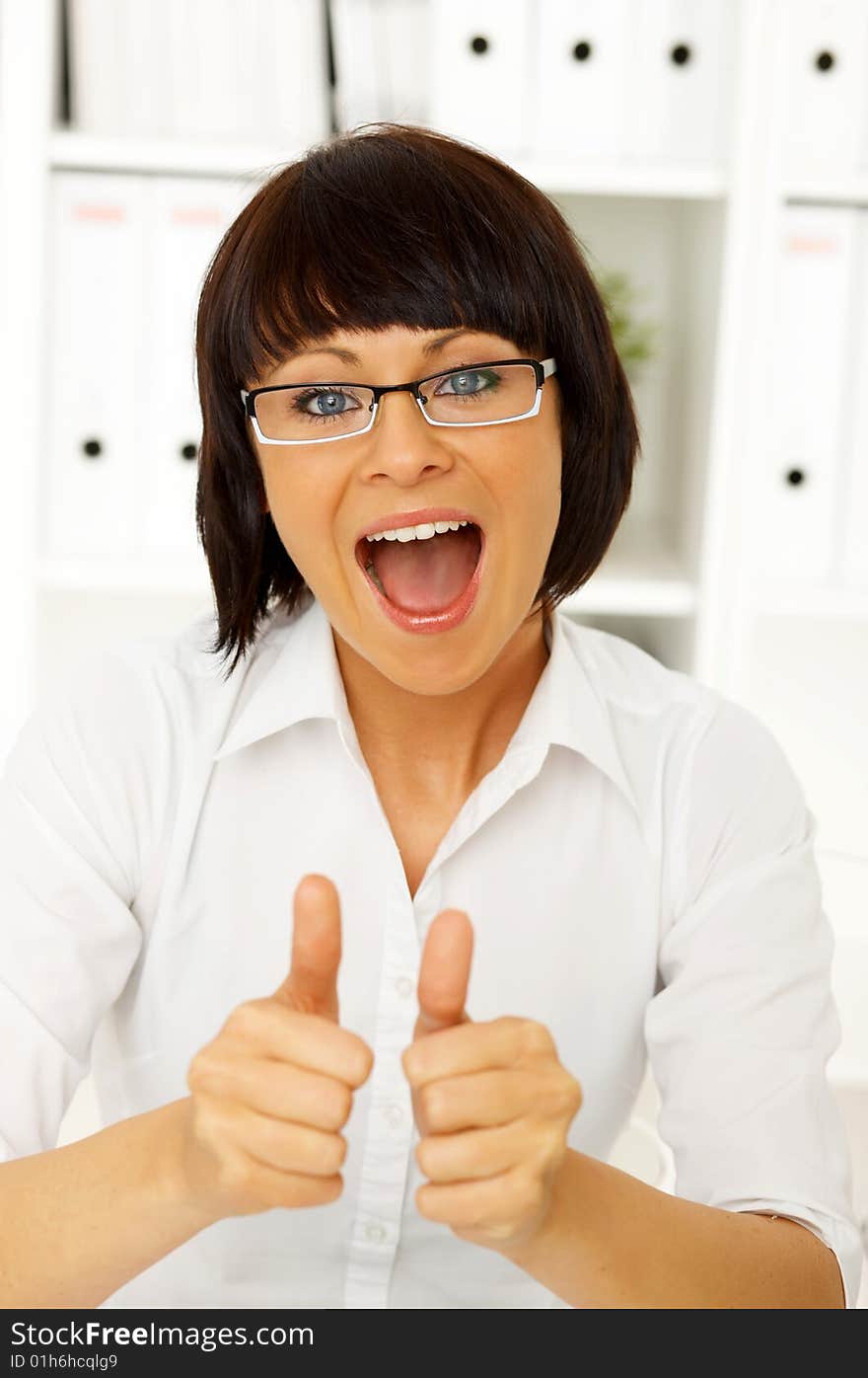 Beautiful business woman sitting at the desk in office. Beautiful business woman sitting at the desk in office