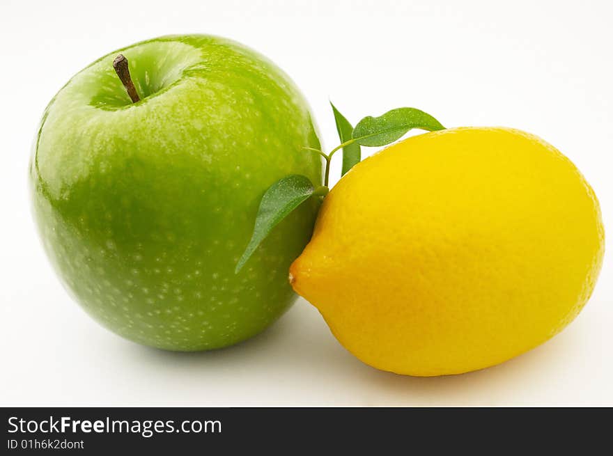 Apple and lemon on a white background