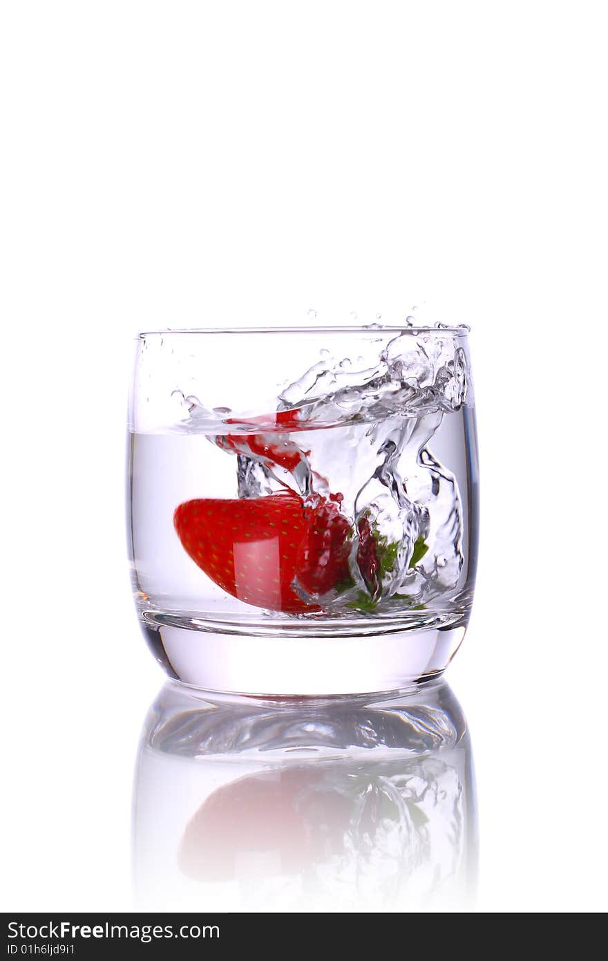 Water glass with strawberry and splash