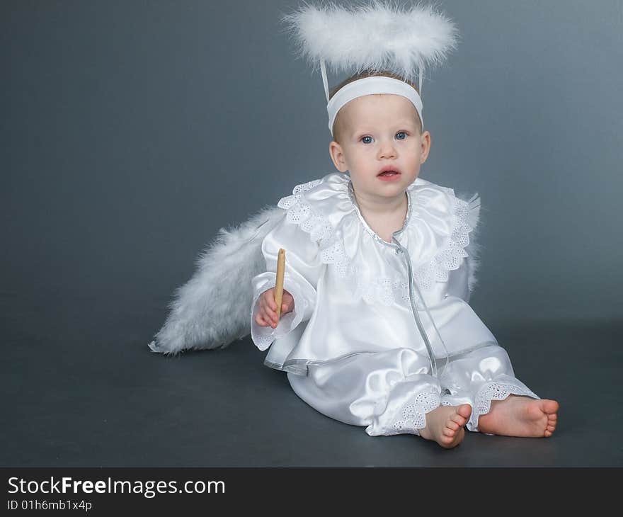 Baby angel girl with fluffy wings, studio shot