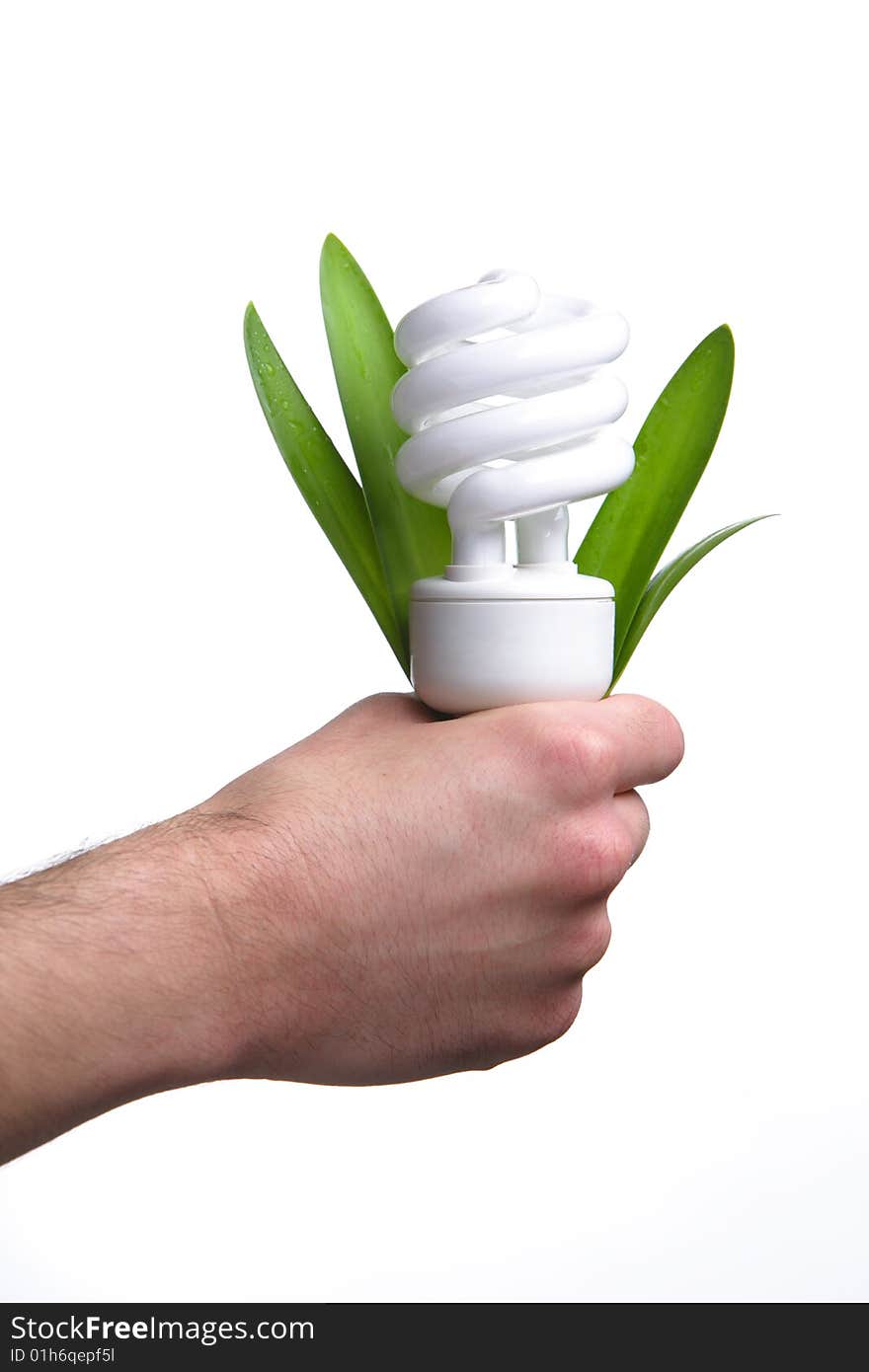 Person holding a modern green light bulb in the studio