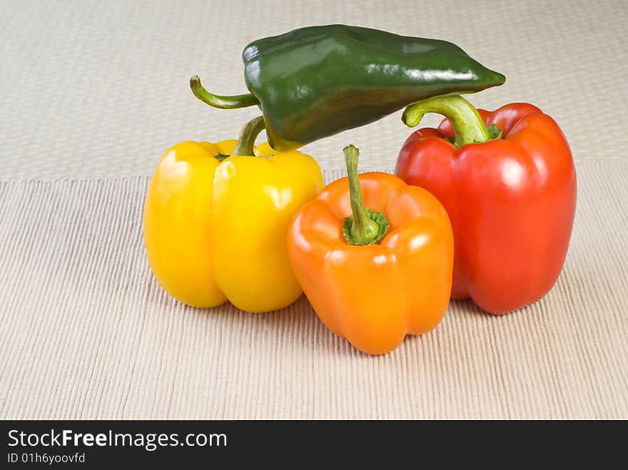 Colorful stacked peppers on a table with copy space