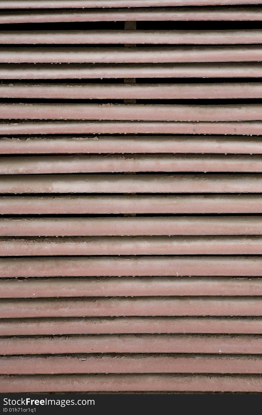 Dirty brown metal grate. Close up