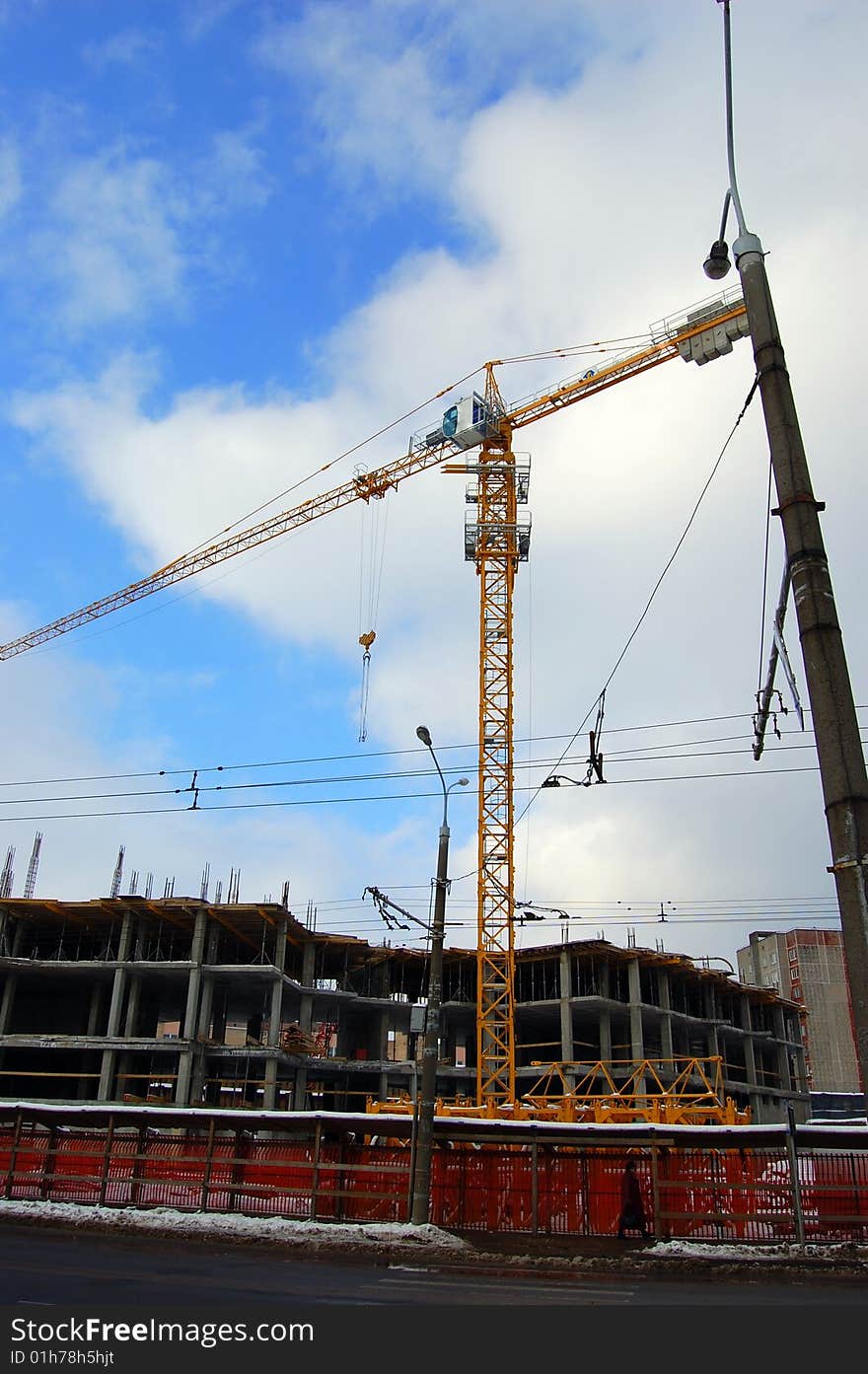 Big yellow hoisting crane building dwelling