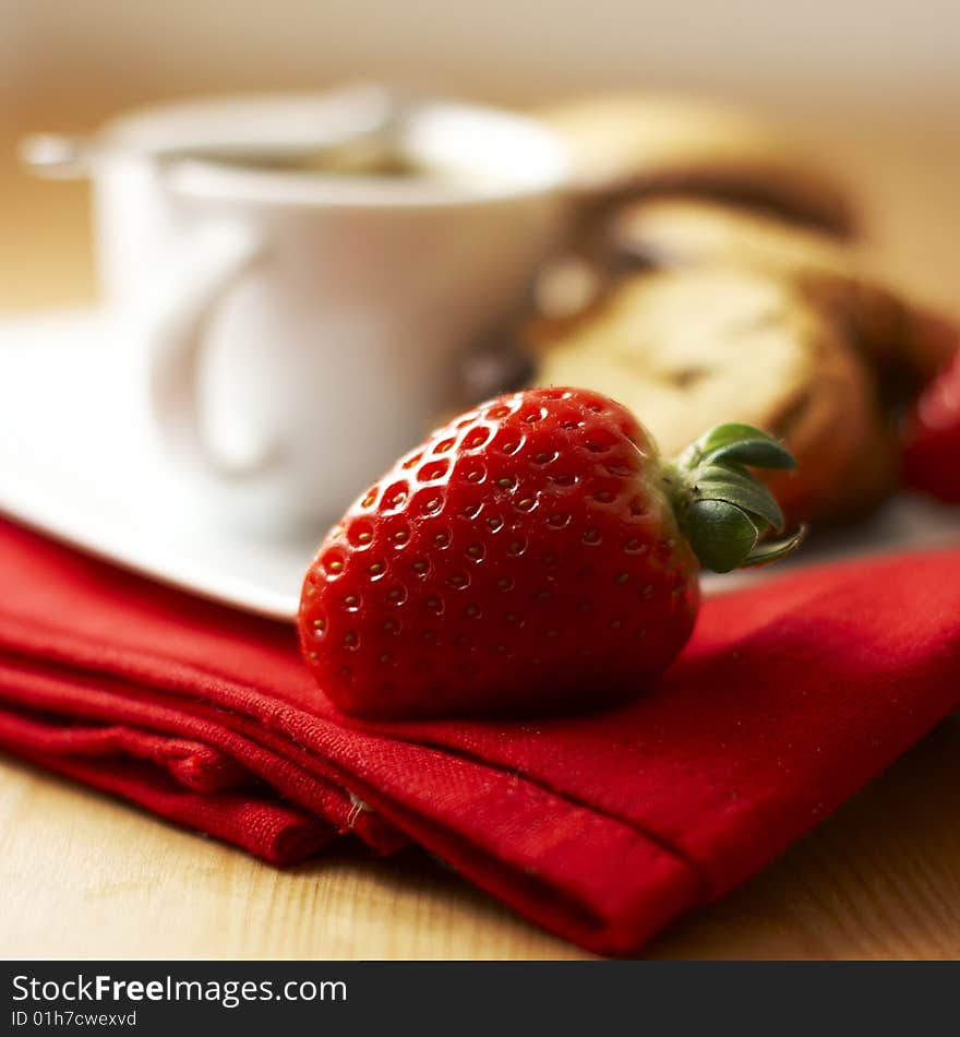 Strawberry with coffee and cookies in the background. Strawberry with coffee and cookies in the background